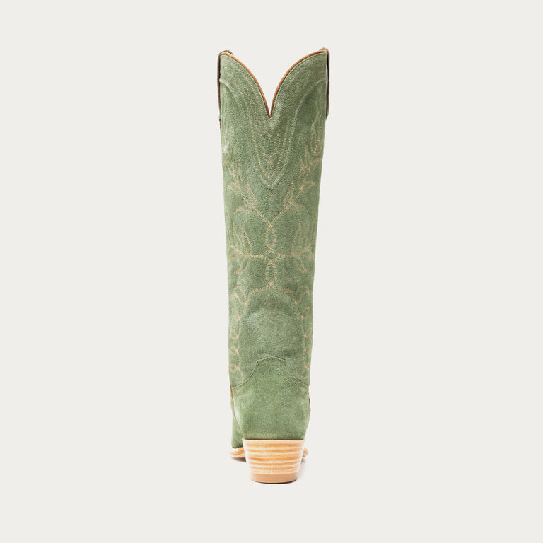 Tall green cowboy boot on a light gray background