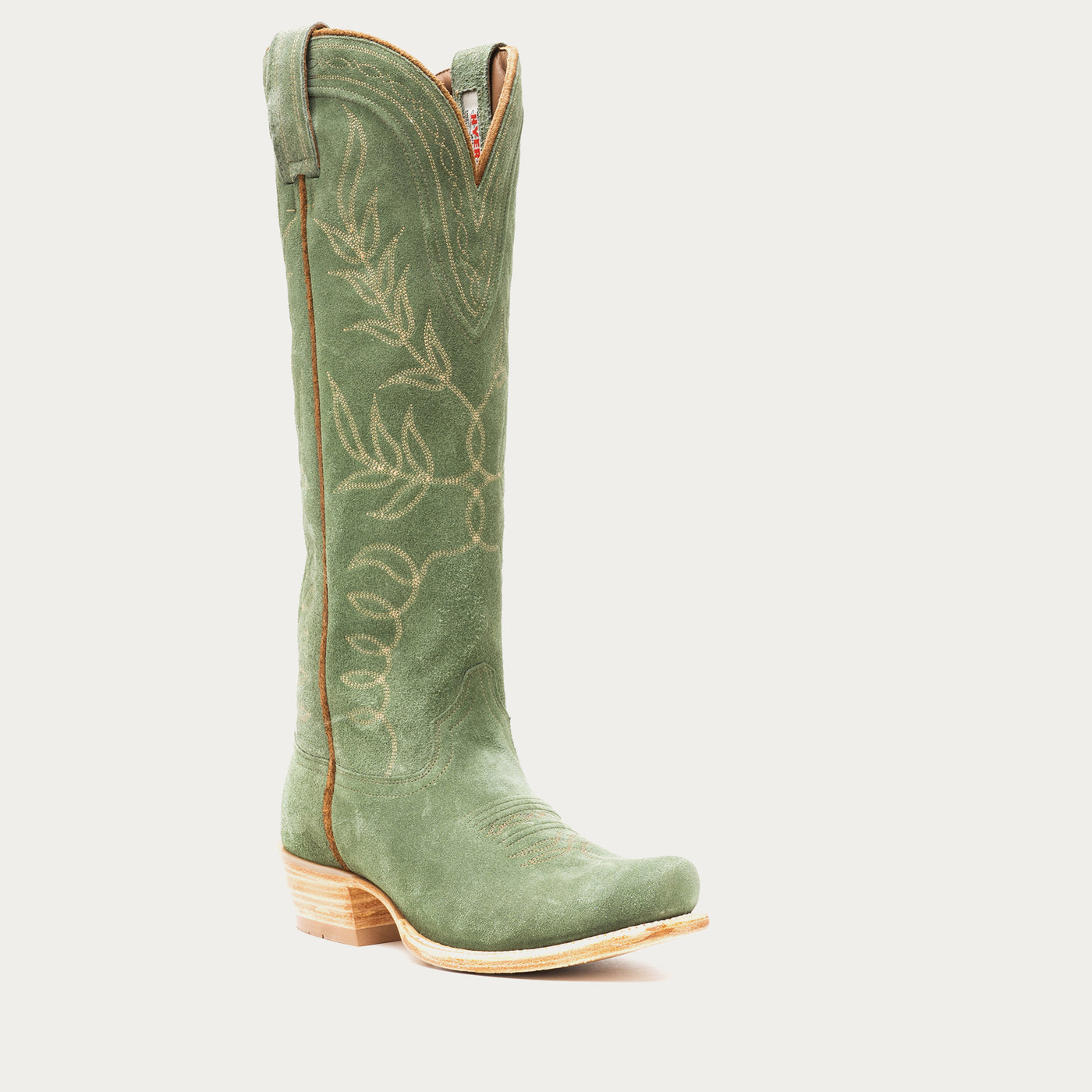 Tall green cowboy boot with floral embroidery on a light gray background