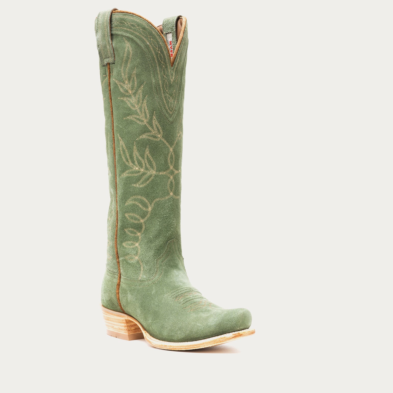 Tall green cowboy boot with floral embroidery on a light gray background
