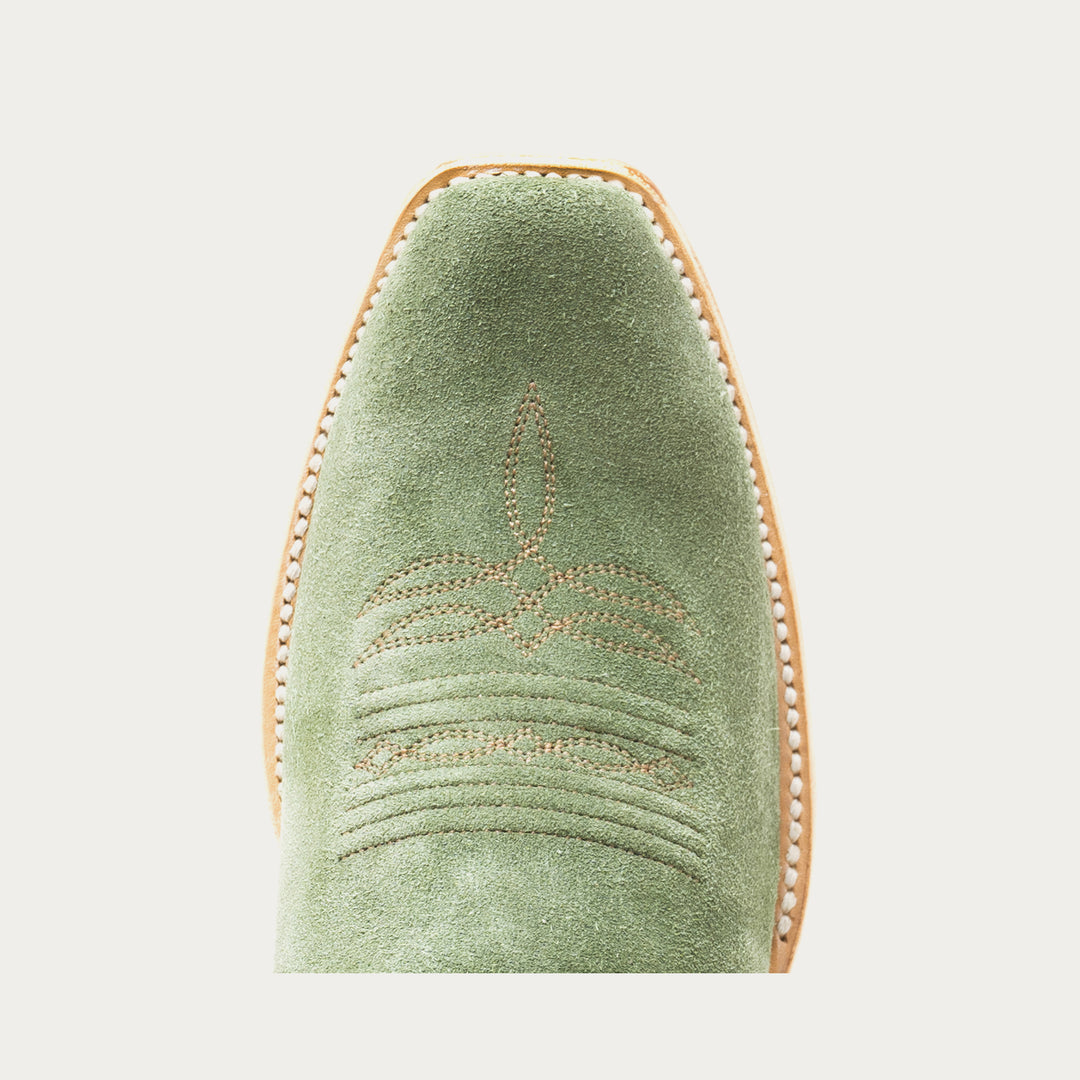 Green boot toe with a subtle design on a light gray background