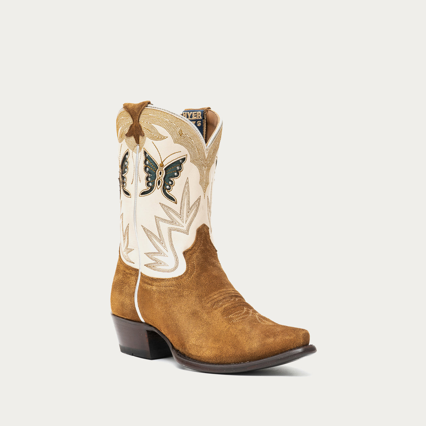 Brown and white cowboy boot with intricate stitching details and butterfly inlays on a light gray background