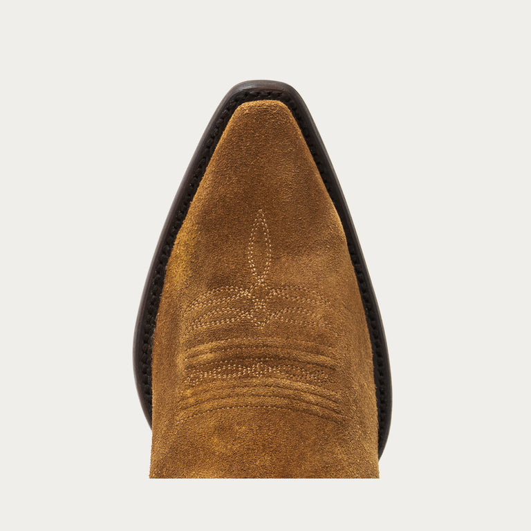 Close-up of a brown leather boot sole on a light gray background