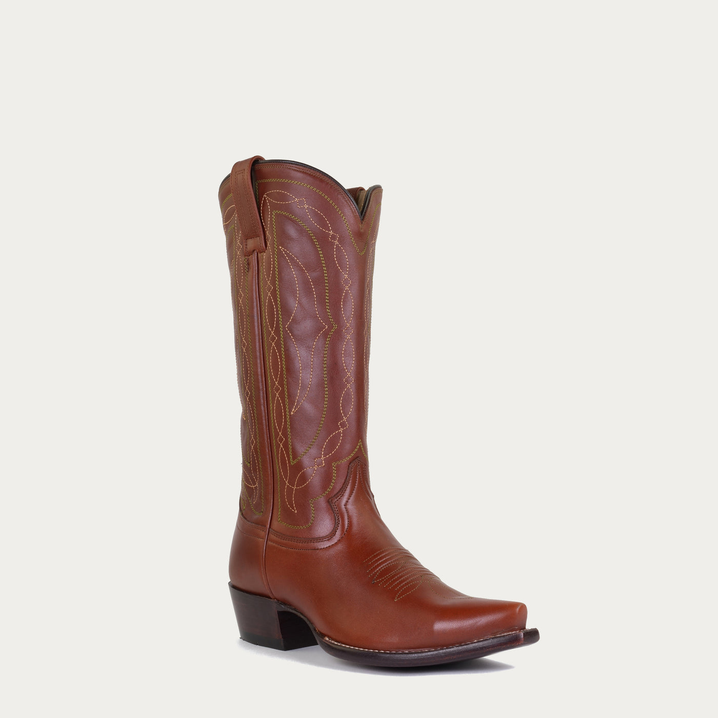 Brown cowboy boot on a light gray background