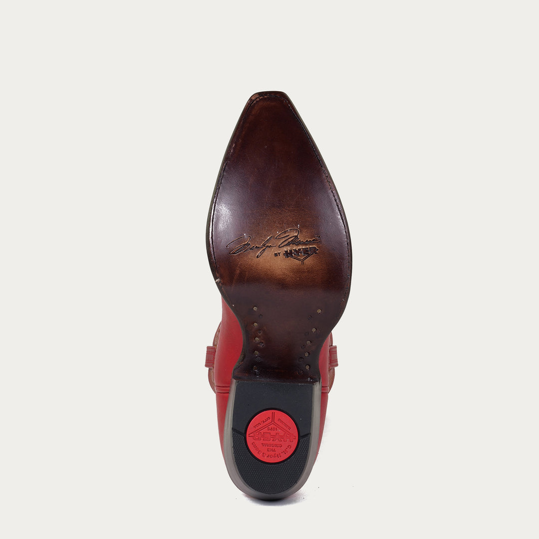 Brown leather sole of cowboy boot with "Marilyn Monroe by HYER" stamped on sole on a light gray background
