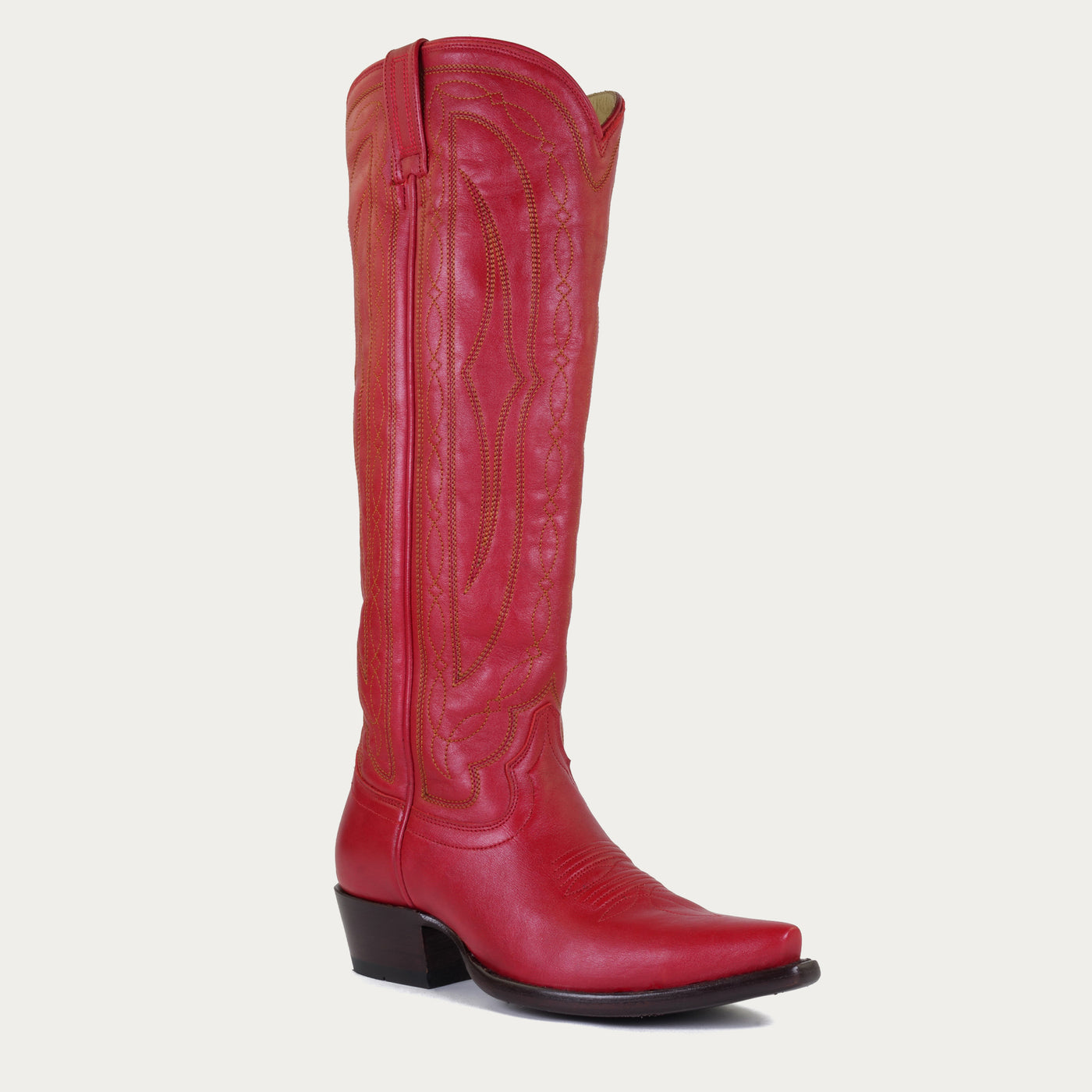 Red leather cowboy boot on a light gray background