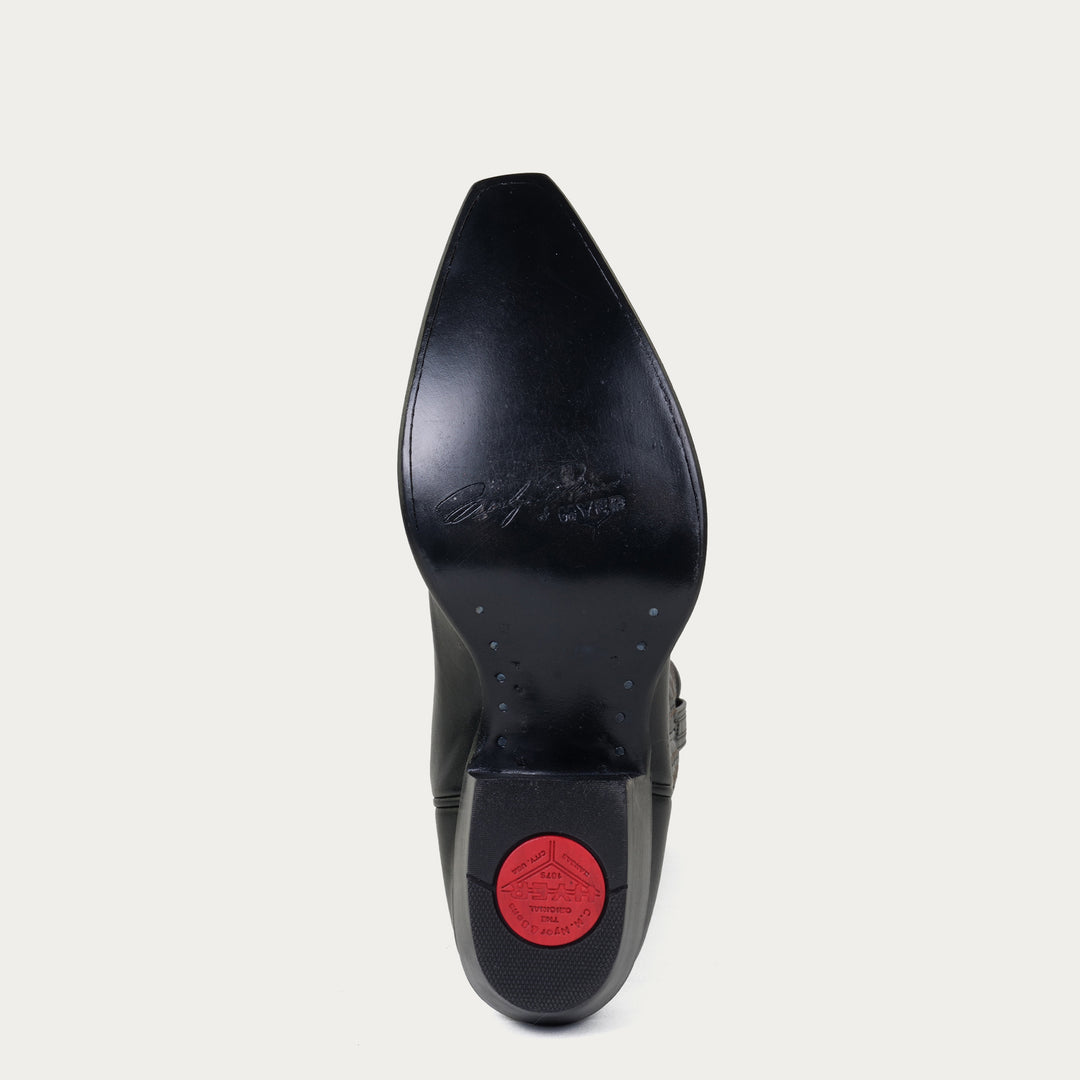 Black leather sole of cowboy boot with "Marilyn Monroe by HYER" stamped on sole on a light gray background