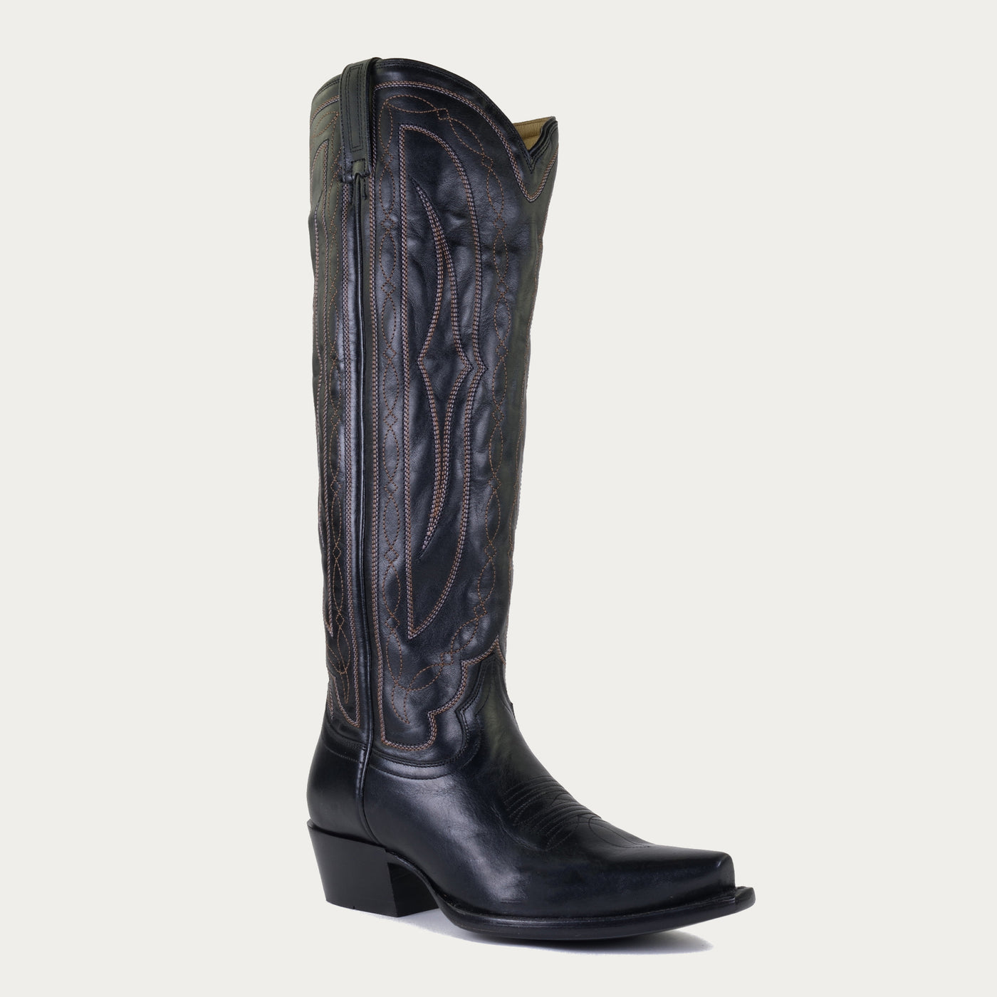 Black leather cowboy boot on a light gray background