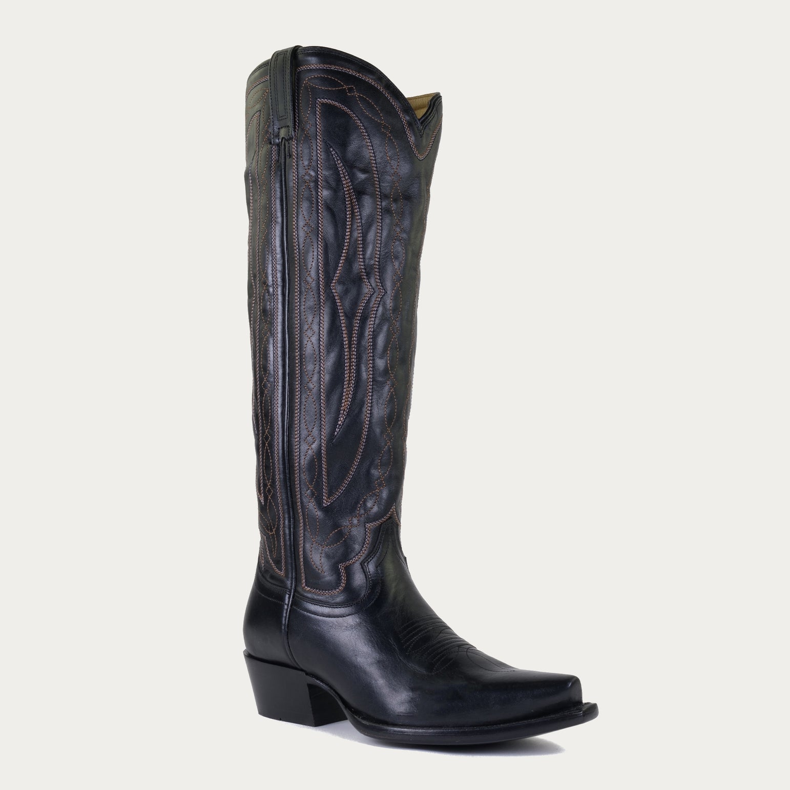 Black leather cowboy boot on a light gray background