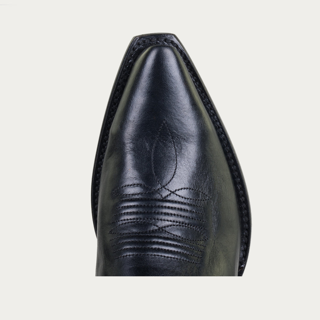 Close-up of a black leather boot with detailed stitching on a light gray background