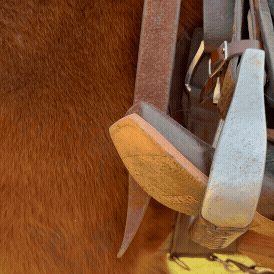 GIF showing cowboy boot with spurs in stirrup