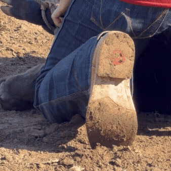 GIF showing soles of cowboy boots digging into dirt